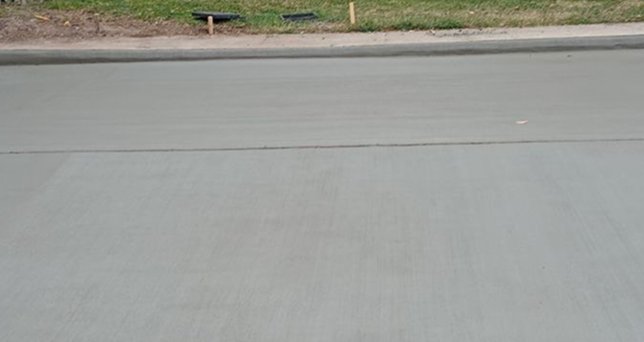 Smooth new concrete slab section with clean control joints