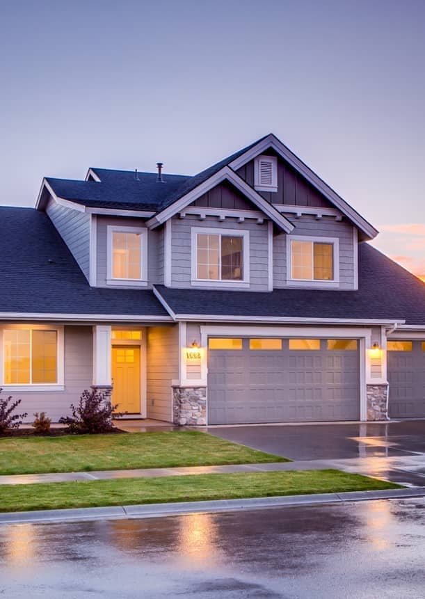 Concrete driveway in front of a two-story home with a two-car garage