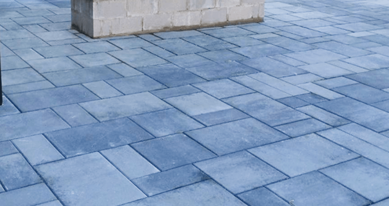 Gray concrete paver patio under a covered pavilion