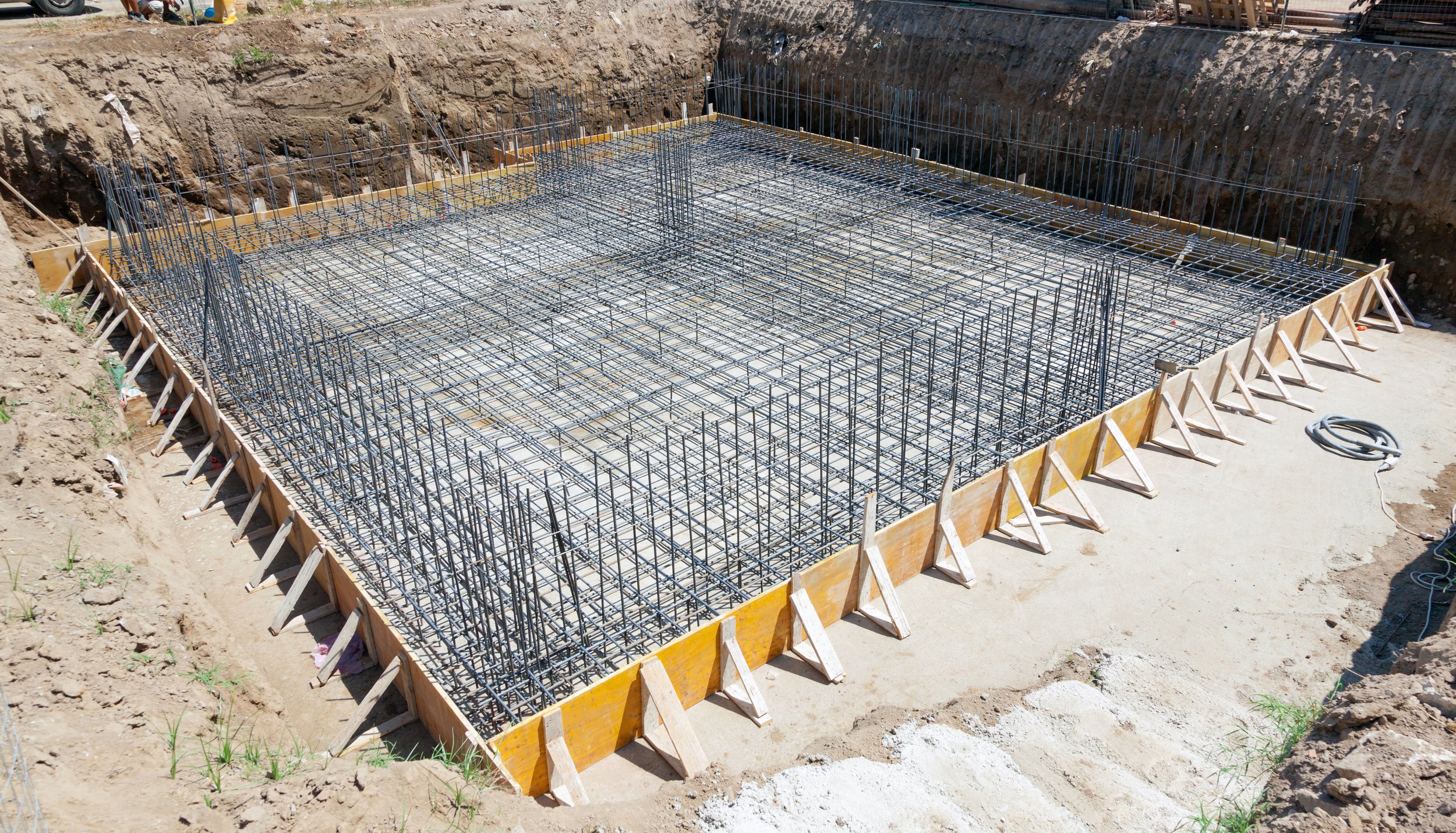 Steel rebar tied inside wood forms before a concrete foundation pour