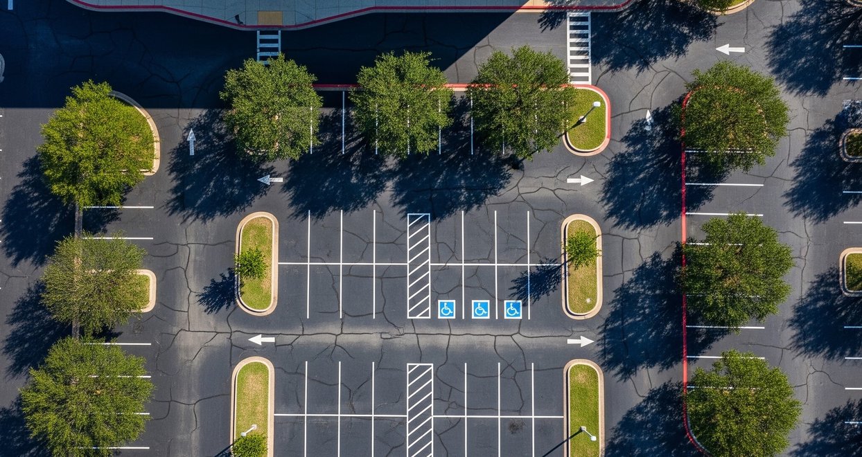 Aerial view of a concrete parking lot with tree islands